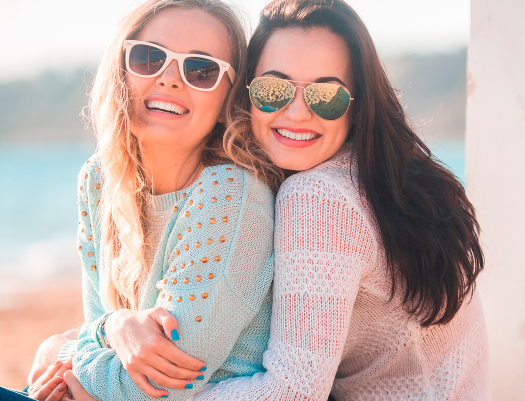 Two women hugging on beach